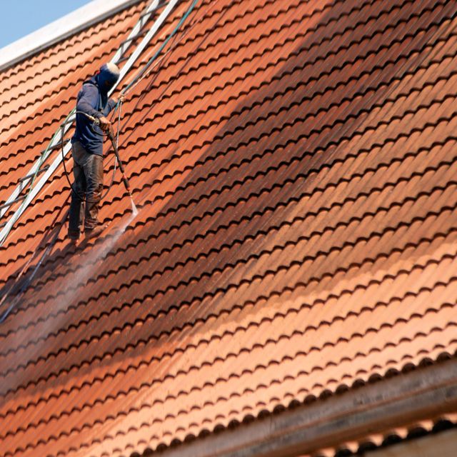 Trabajador limpiando tejas